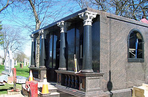 Polished tapered black granite columns of mausoleum.