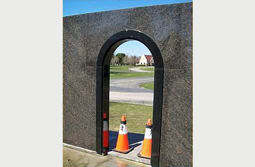 Private Mausoleum black granite door frame with semi-circle arched top.