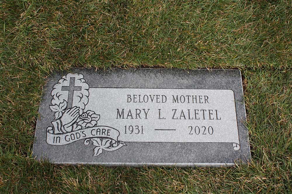 Dark grey marker with cross and verse