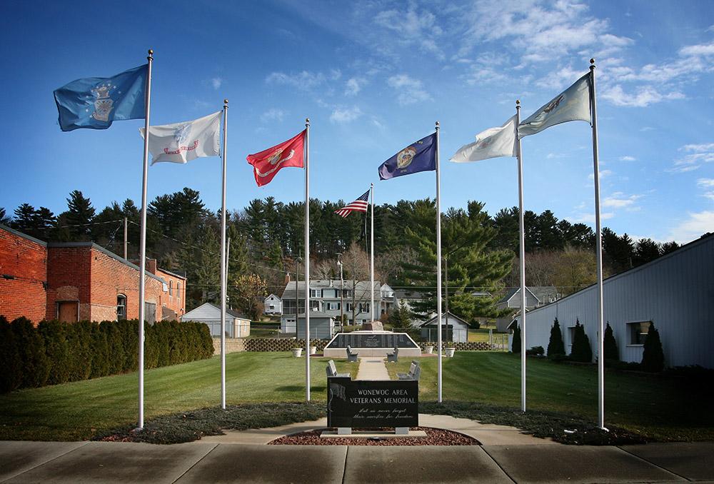 Flags waving in wind at Wonewoc WI Veterans Memorial